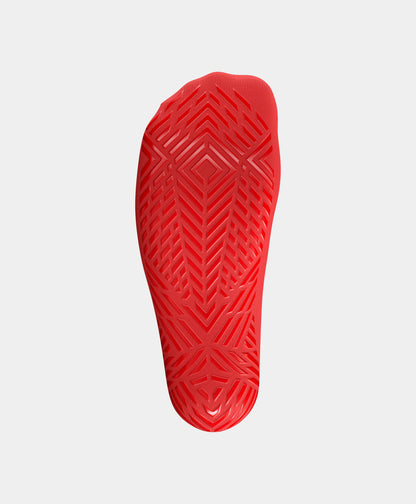 Athlete adjusting Icon Mid-Calf Football Grip Socks, showcasing the fit and comfort.
