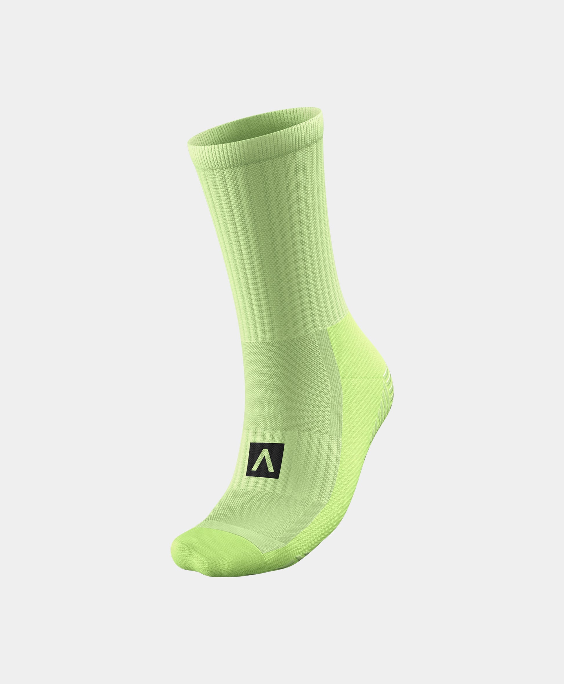 A pair of Reflective Mid-Calf Football Grip Socks positioned to showcase their unique grip technology.